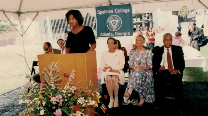 Stacey Abrams at a podium speaking to Spelman College in Atlanta, Georgia